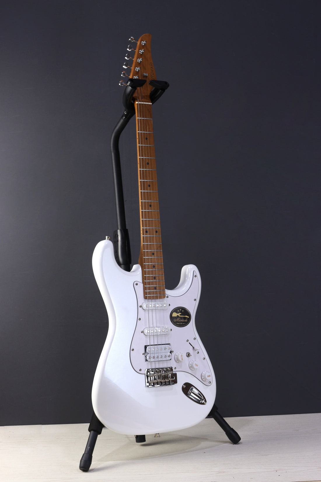 Front view of Mirsock DLX60 Pearl White showcasing custom pickups and vintage ST tremolo bridge